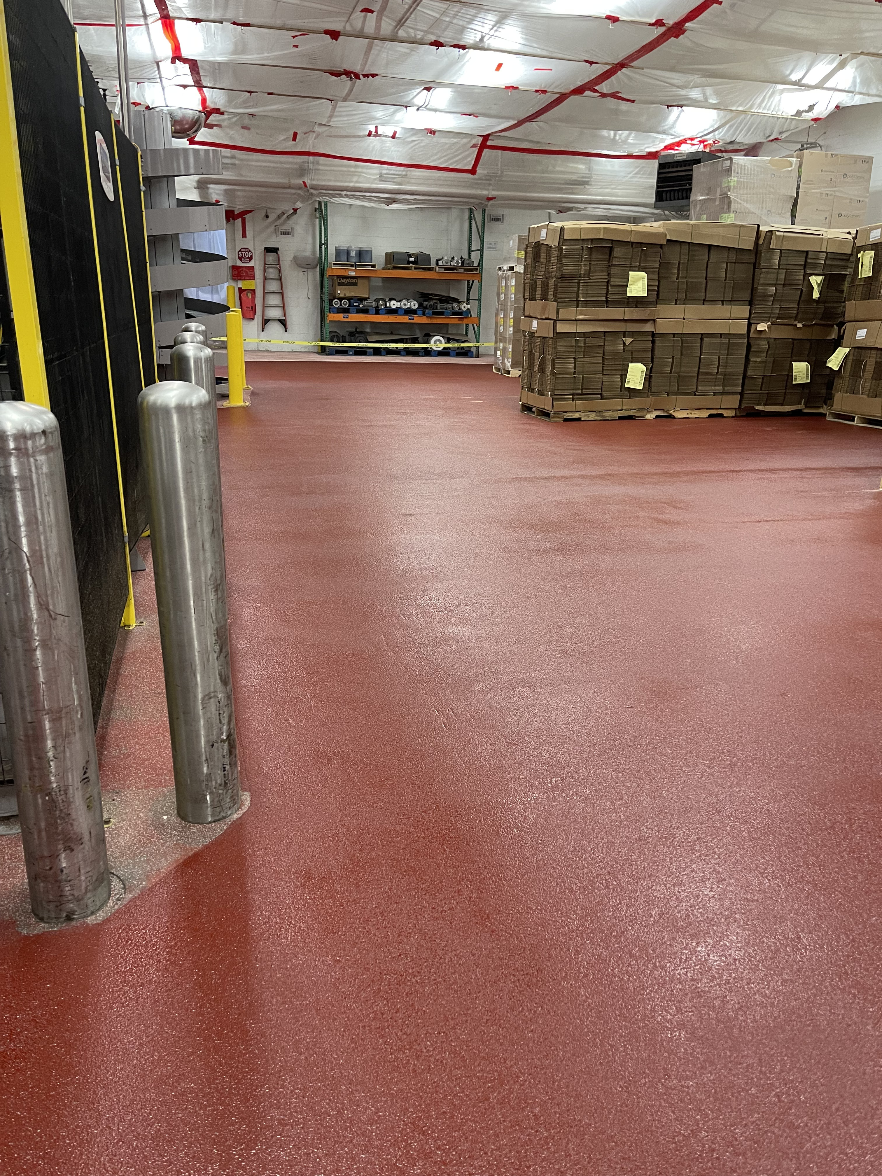 Red epoxy flooring in a warehouse
